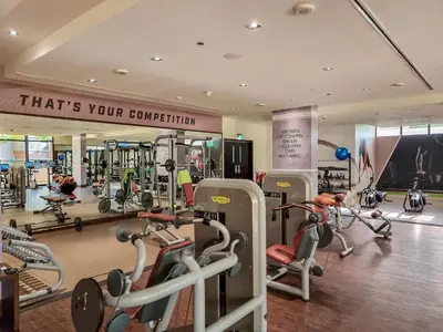 a gym with lots of treadmills and machines at Full Sea View 1 BR with Lagoon Pool & Beach Access in Dubai