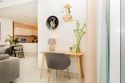 a living room with a table and a chair at Dubai Marina - 1BHK Apartment in Dubai
