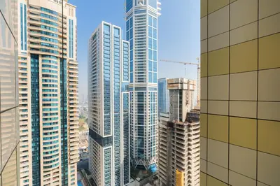 a view of a large city with tall buildings at Dubai Marina - 1BHK Apartment in Dubai