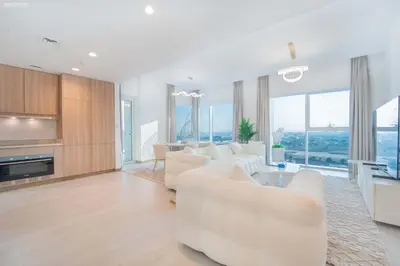 a living room with white furniture and large windows at Fabulous Missoni Designer Building, 3 bedroom plus maid in Dubai