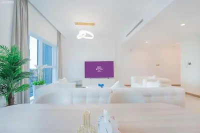 a white living room with white couches and a table at Fabulous Missoni Designer Building, 3 bedroom plus maid in Dubai