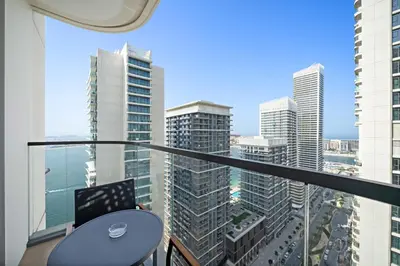 a balcony with a table and a view of a city at Silkhaus Sea & City View 1BDR in Exclusive Neighbourhood in Dubai