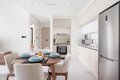 a kitchen and dining room with a table and chairs at Silkhaus Sea & City View 1BDR in Exclusive Neighbourhood in Dubai