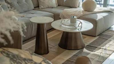 a living room with two tables and a couch at Sky-High 1BR RetreatMarina VistaEmaar Beachfront in Dubai
