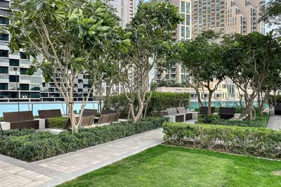 a park with benches and trees in a city at Downtown 3BR Sleeps 9 Balcony, Full Kitchen, Near Metro in Dubai