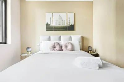 a bedroom with a large white bed with two pillows at Apartment KOYO in the heart of JBR Beach - 3BDR in Dubai