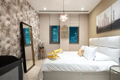 a bedroom with a white bed and windows at Apartment KOYO in the heart of JBR Beach - 3BDR in Dubai