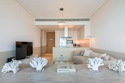 a living room with a couch and a table at Address JBR 2 Bedroom With Beach Access by Millennium Vacation Homes in Dubai