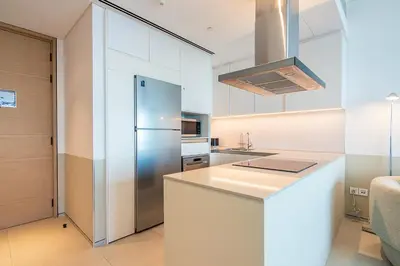 a kitchen with a refrigerator and a counter top at Address JBR 2 Bedroom With Beach Access by Millennium Vacation Homes in Dubai