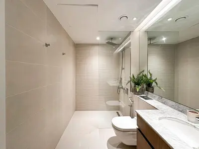 a bathroom with a toilet and a sink and a mirror at HiGuests - Luxurious Boho Beach 2BR Apartment in La Mer in Dubai