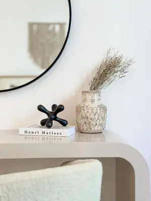 a table with a mirror and a vase on it at HiGuests - Luxurious Boho Beach 2BR Apartment in La Mer in Dubai