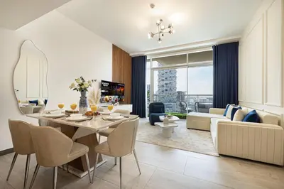 a dining room and living room with a table and chairs at SmartStay at Zaya Hameni - Modern Luxury Apartments - Unique in JVC in Dubai