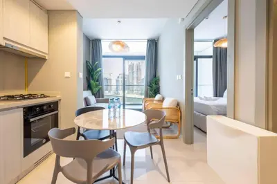 a kitchen and living room with a table and chairs at 1BR Apartment in Zada Tower Business Bay - Close to Metro in Dubai