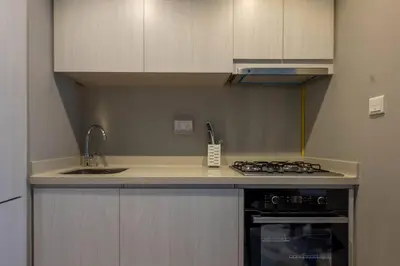 a kitchen with a sink and a stove at 1BR Apartment in Zada Tower Business Bay - Close to Metro in Dubai