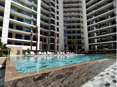 a swimming pool in front of a large building at 1BR Apartment in Zada Tower Business Bay - Close to Metro in Dubai