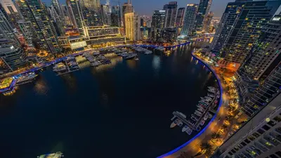 an aerial view of a city at night with a harbor at Top-Floor Luxury 2BR with Stunning Marina View in Dubai