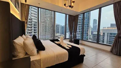 a bedroom with a large bed with a view of a city at Panoramic 1BR Stunning Marina Views Near JBR Beach by Maxx Value Homes in Dubai