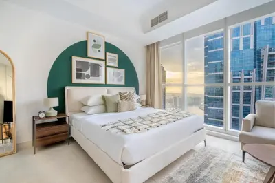 a bedroom with a large bed and a large window at GuestReady - A Dream Getaway at Business Bay in Dubai