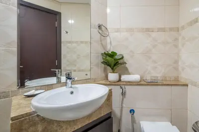 a bathroom with a white sink and a tub at GuestReady - A Dream Getaway at Business Bay in Dubai