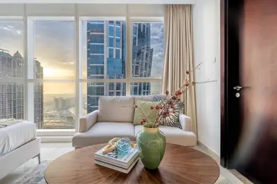 a living room with a couch and a vase on a table at GuestReady - A Dream Getaway at Business Bay in Dubai