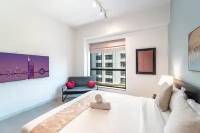 a living room with a large bed and a couch at Prime Spacious 5 plus 1 BR Apt on JBR Beach near Metro ,Walk to The Mall, Dining & Entertainment - By Sunkissed Holiday Homes in Dubai