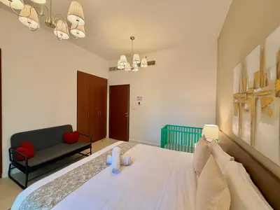 a bedroom with a large bed and a couch at Prime Specious 4 BR Apt on JBR Beach near Metro, Walk to The Mall, Dining & Entertainment - By Sunkissed Holiday Homes in Dubai