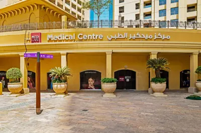 a medical centre with potted plants in front of a building at Prime Specious 4 BR Apt on JBR Beach near Metro, Walk to The Mall, Dining & Entertainment - By Sunkissed Holiday Homes in Dubai