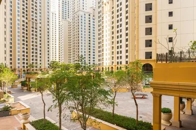 a courtyard in a city with tall buildings at Prime Specious 4 BR Apt on JBR Beach near Metro, Walk to The Mall, Dining & Entertainment - By Sunkissed Holiday Homes in Dubai