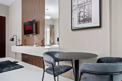 a dining room with a table and two chairs at Hidden Gem - Comfort And Family Friendly in Dubai