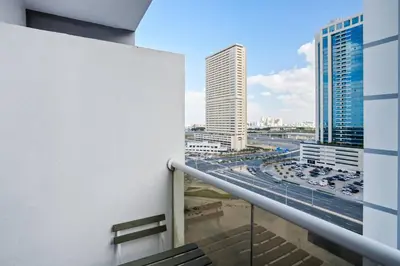 a balcony with a view of a city at Hidden Gem - Comfort And Family Friendly in Dubai