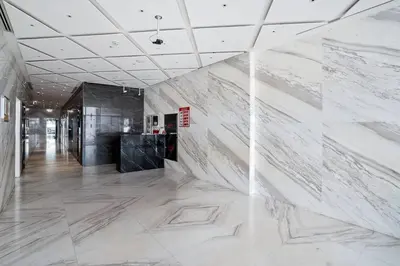 a hallway with marble walls in a building at Hidden Gem - Comfort And Family Friendly in Dubai