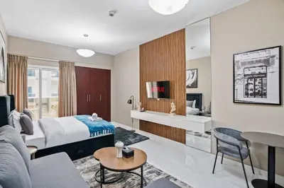 a hotel room with a bed and a living room at Hidden Gem - Comfort And Family Friendly in Dubai