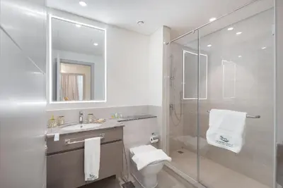 a bathroom with a shower and a toilet and a sink at Heaven Crest Vacation Homes - Luxury Forte in Dubai