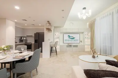 a living room and kitchen with a table and chairs at Heaven Crest Vacation Homes - Luxury Forte in Dubai