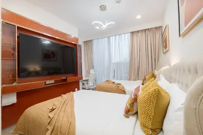 a hotel room with a bed and a flat screen tv at Heaven Crest Vacation Homes - Luxury Forte in Dubai