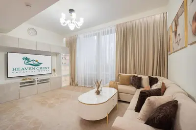a living room with a couch and a tv at Heaven Crest Vacation Homes - Luxury Forte in Dubai