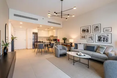 a living room with a couch and a table at Modern 1BDR Apartment I Madinat Jumeirah Living I Asayel 3 in Dubai