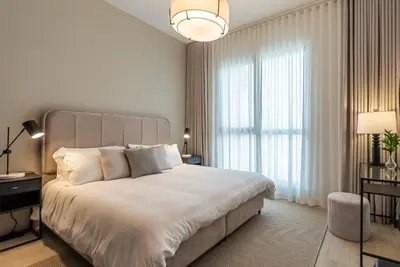 a bedroom with a large bed and a large window at Modern 1BDR Apartment I Madinat Jumeirah Living I Asayel 3 in Dubai