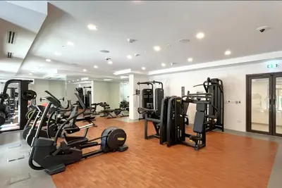 a gym with several treadmills and elliptical machines at Modern 1BDR Apartment I Madinat Jumeirah Living I Asayel 3 in Dubai