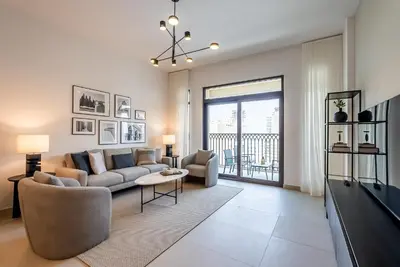 a living room with a couch and a table at Modern 1BDR Apartment I Madinat Jumeirah Living I Asayel 3 in Dubai