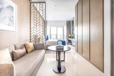a living room with a couch and a table at Studio Apartment in DAMAC Maison Prive Business Bay - High Floor in Dubai