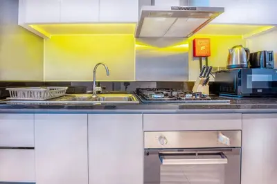 a kitchen with a sink and a stove at Studio Apartment in DAMAC Maison Prive Business Bay - High Floor in Dubai