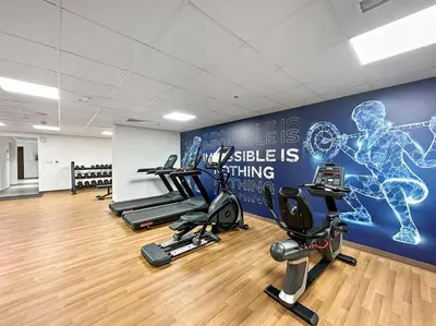 a gym with treadmills and cardio equipment in a room at Stylish 1 BR in Al Furjan in Dubai