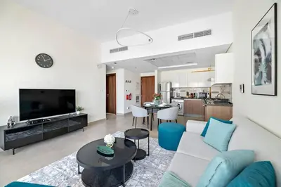 a living room with a couch and a table at Stylish 1 BR in Al Furjan in Dubai