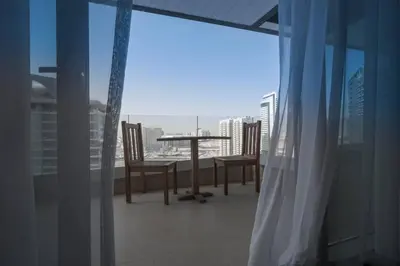 a view of a balcony with a table and chairs at Cozy Studio in Sports City in Dubai