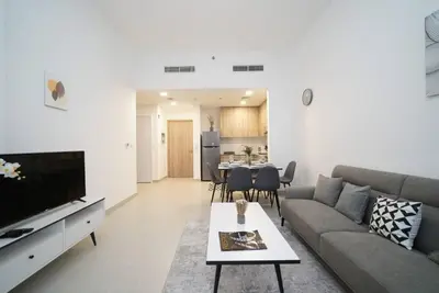 a living room with a couch and a table at Spacious 1 BR in Peaceful Community in Dubai