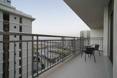 a balcony with a table and chairs on a building at Spacious 1 BR in Peaceful Community in Dubai