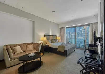 a hotel room with a bed and a couch at Dubai Marina Residences, Studio with Balcony Connected to Marina Mall in Dubai