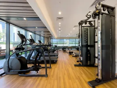 a gym with treadmills and elliptical machines at Zada Tower 1BR with amazing Dubai Canal view in Dubai
