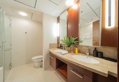 a bathroom with a sink and a toilet and a mirror at EDEN'S Homes & Villas - Standpoint Residences in Dubai